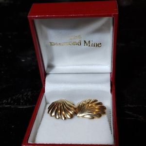 Gold tone earrings.  Shell shape.